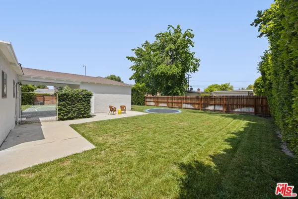 a view of backyard with a garden and entertaining space