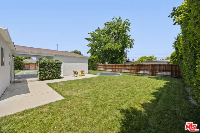 a view of backyard with a garden and entertaining space