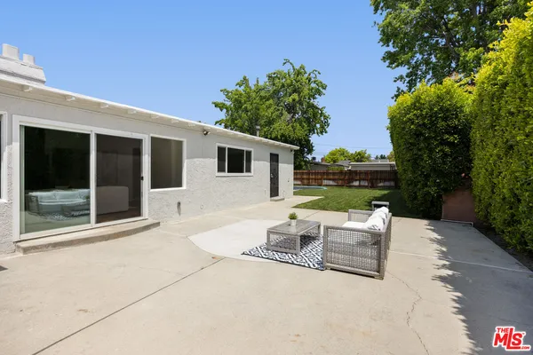 a backyard of a house with outdoor seating