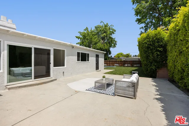 a backyard of a house with outdoor seating