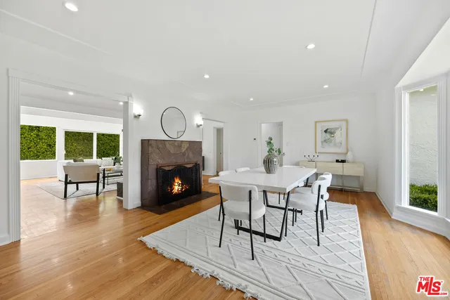 a living room with furniture a fireplace and wooden floor