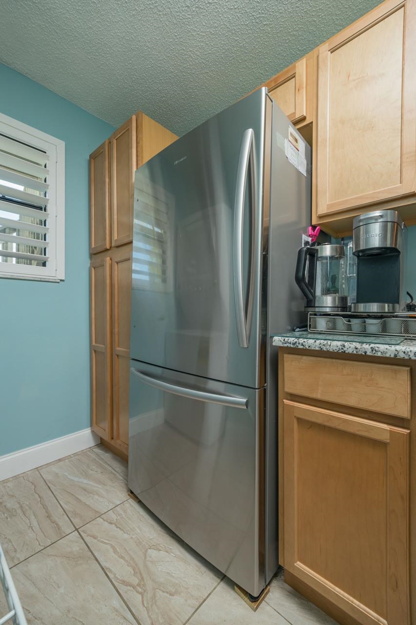 650 West Pope Road, Unit 240 St. Augustine, FL 32080 - Photo 15 of 35 a kitchen with stainless steel appliances granite countertop a refrigerator and a sink