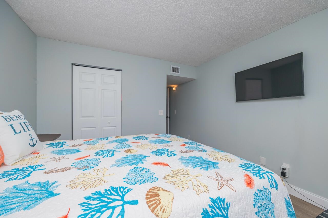 650 West Pope Road, Unit 240 St. Augustine, FL 32080 - Photo 18 of 35 a bedroom with a bed and a television