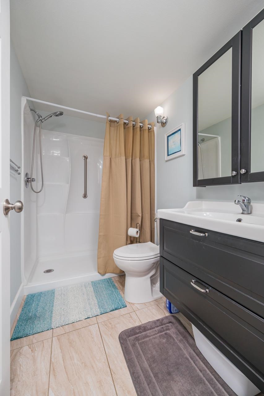 650 West Pope Road, Unit 240 St. Augustine, FL 32080 - Photo 19 of 35 a bathroom with a toilet a sink and a mirror