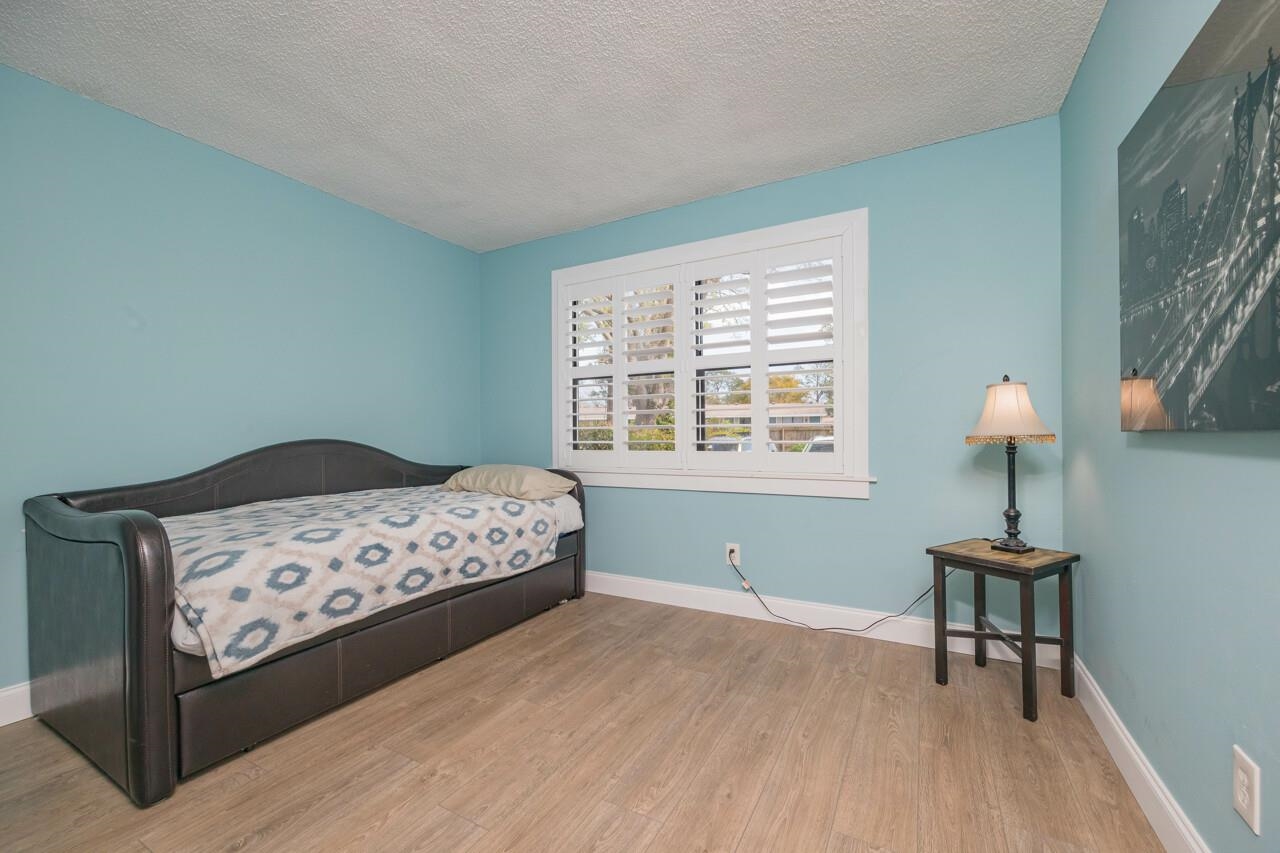 650 West Pope Road, Unit 240 St. Augustine, FL 32080 - Photo 22 of 35 a bedroom with a bed and a lamp