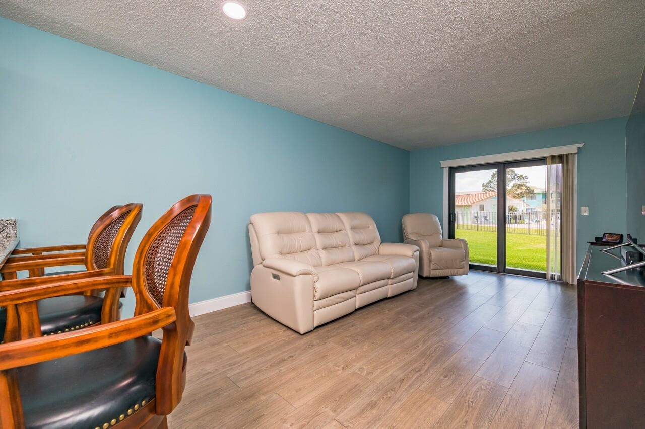 650 West Pope Road, Unit 240 St. Augustine, FL 32080 - Photo 5 of 35 a living room with furniture and a large window