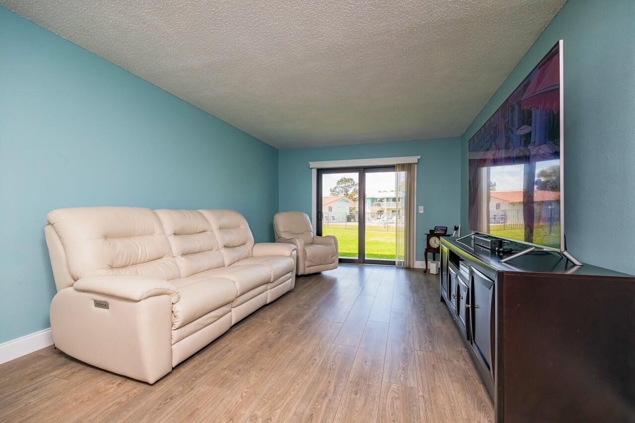 650 West Pope Road, Unit 240 St. Augustine, FL 32080 - Photo 6 of 35 a living room with furniture and a flat screen tv