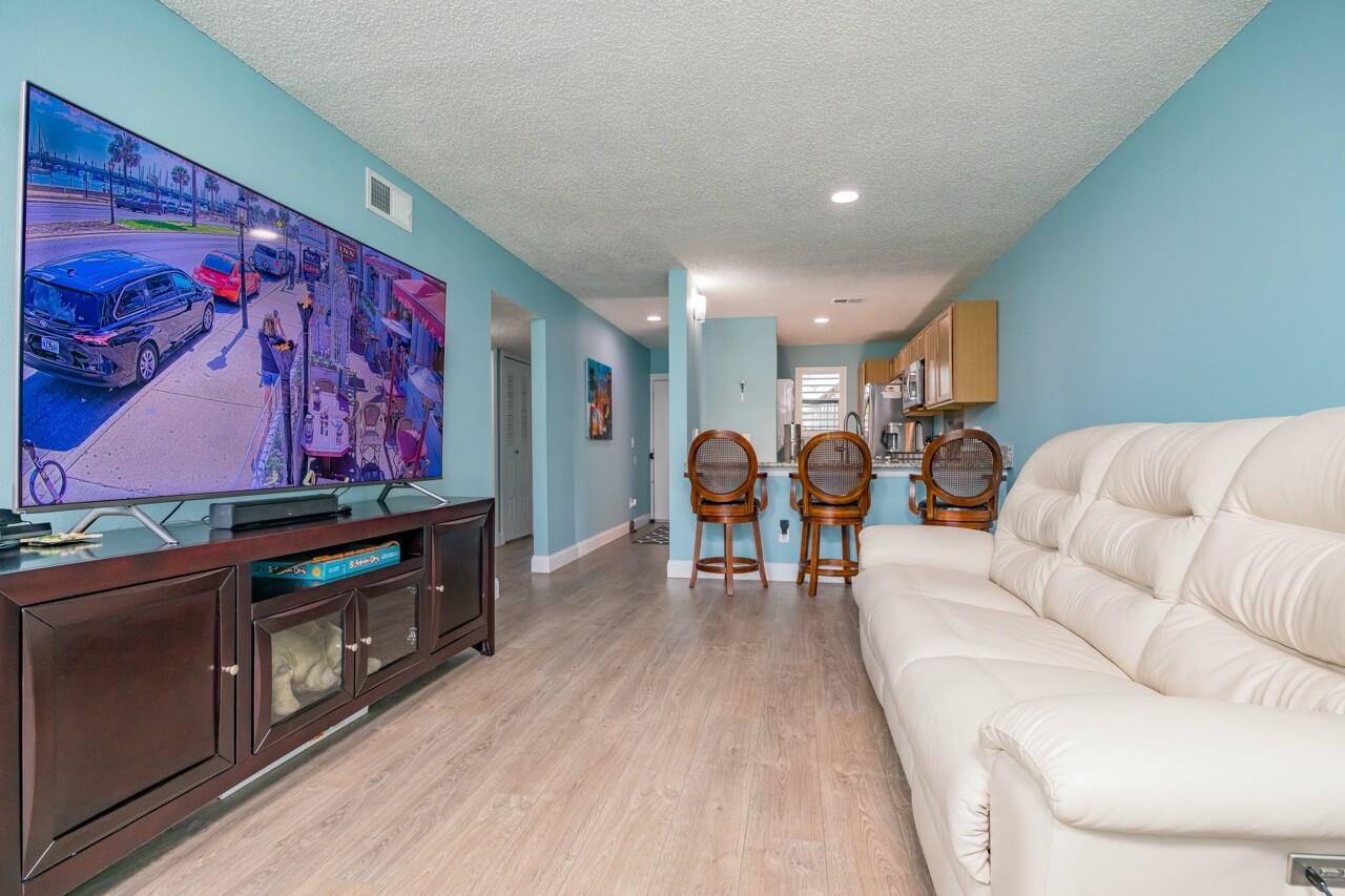 650 West Pope Road, Unit 240 St. Augustine, FL 32080 - Photo 8 of 35 a living room with furniture and a flat screen tv