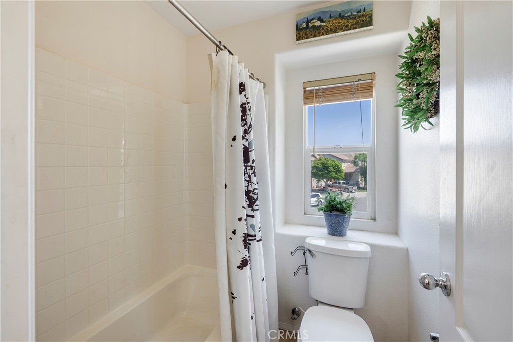 3819 St Austell Way Perris, CA 92571 - Photo 30 of 64 a bathroom with a toilet and a shower