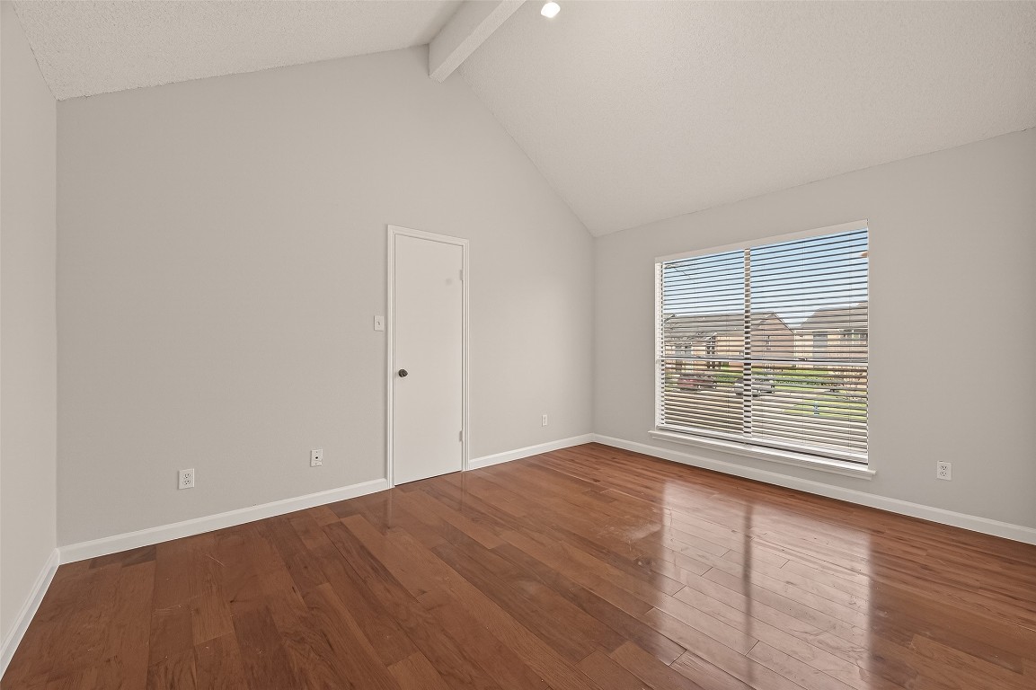 8483 Sands Point Drive Houston, TX 77036 - Photo 11 of 23 wooden floor in an empty room with a window