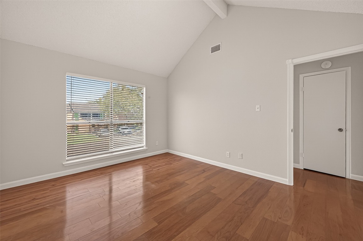 8483 Sands Point Drive Houston, TX 77036 - Photo 12 of 23 a view of an empty room with wooden floor and a window