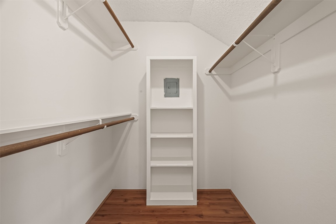 8483 Sands Point Drive Houston, TX 77036 - Photo 13 of 23 a view of walk in closet with empty racks