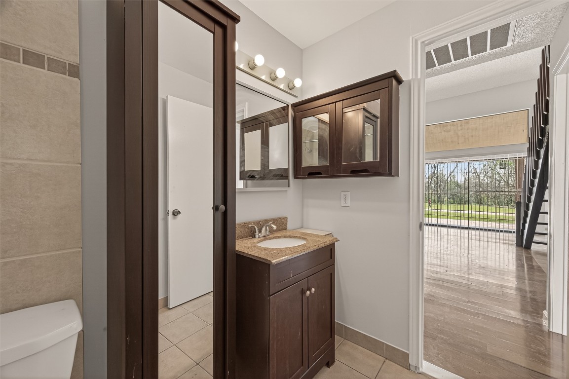 8483 Sands Point Drive Houston, TX 77036 - Photo 15 of 23 a bathroom with a sink and a mirror