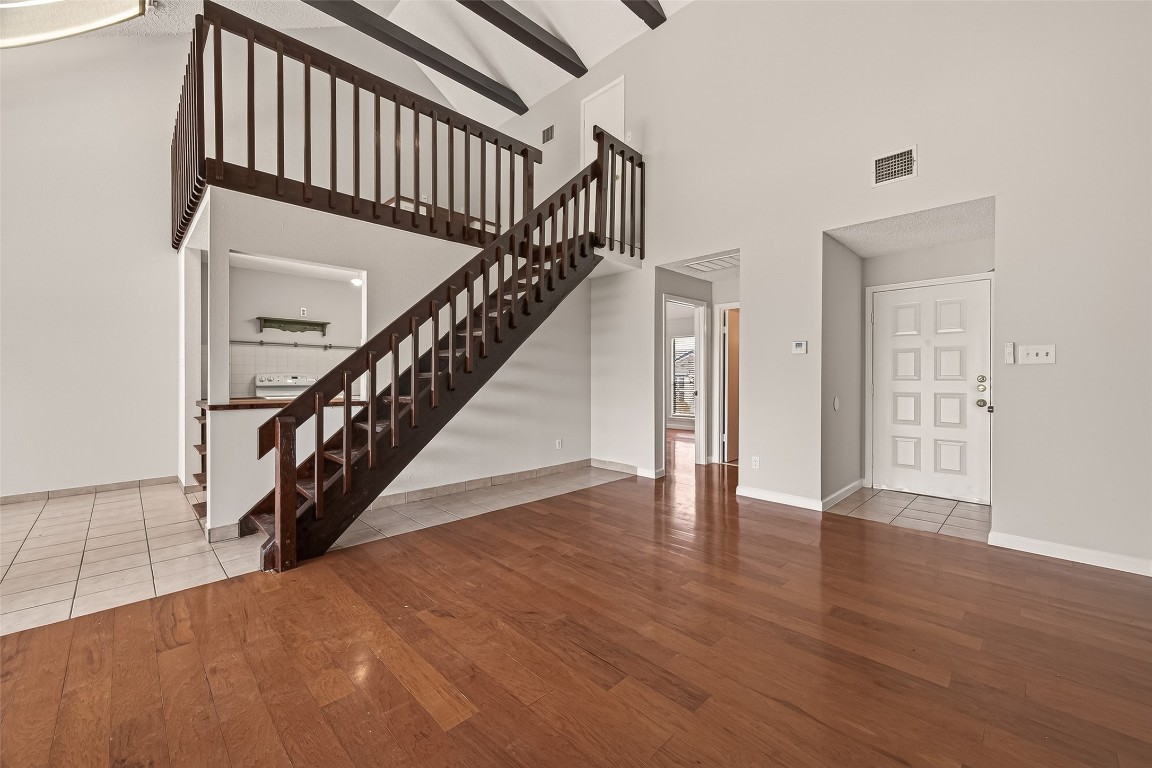 8483 Sands Point Drive Houston, TX 77036 - Photo 16 of 23 a view of staircase with wooden floor and white walls