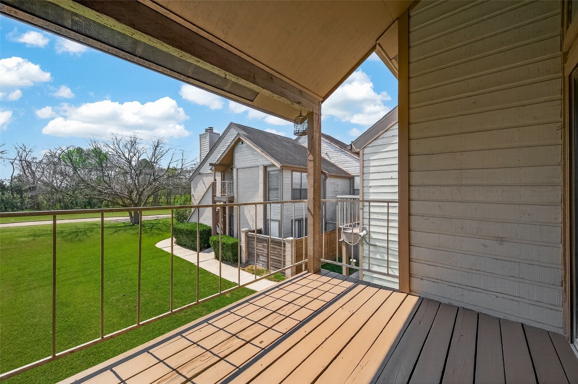 8483 Sands Point Drive Houston, TX 77036 - Photo 19 of 23 a view of a balcony with wooden floor and fence