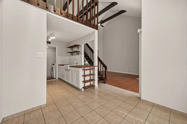 a view of a balcony with wooden floor and fence