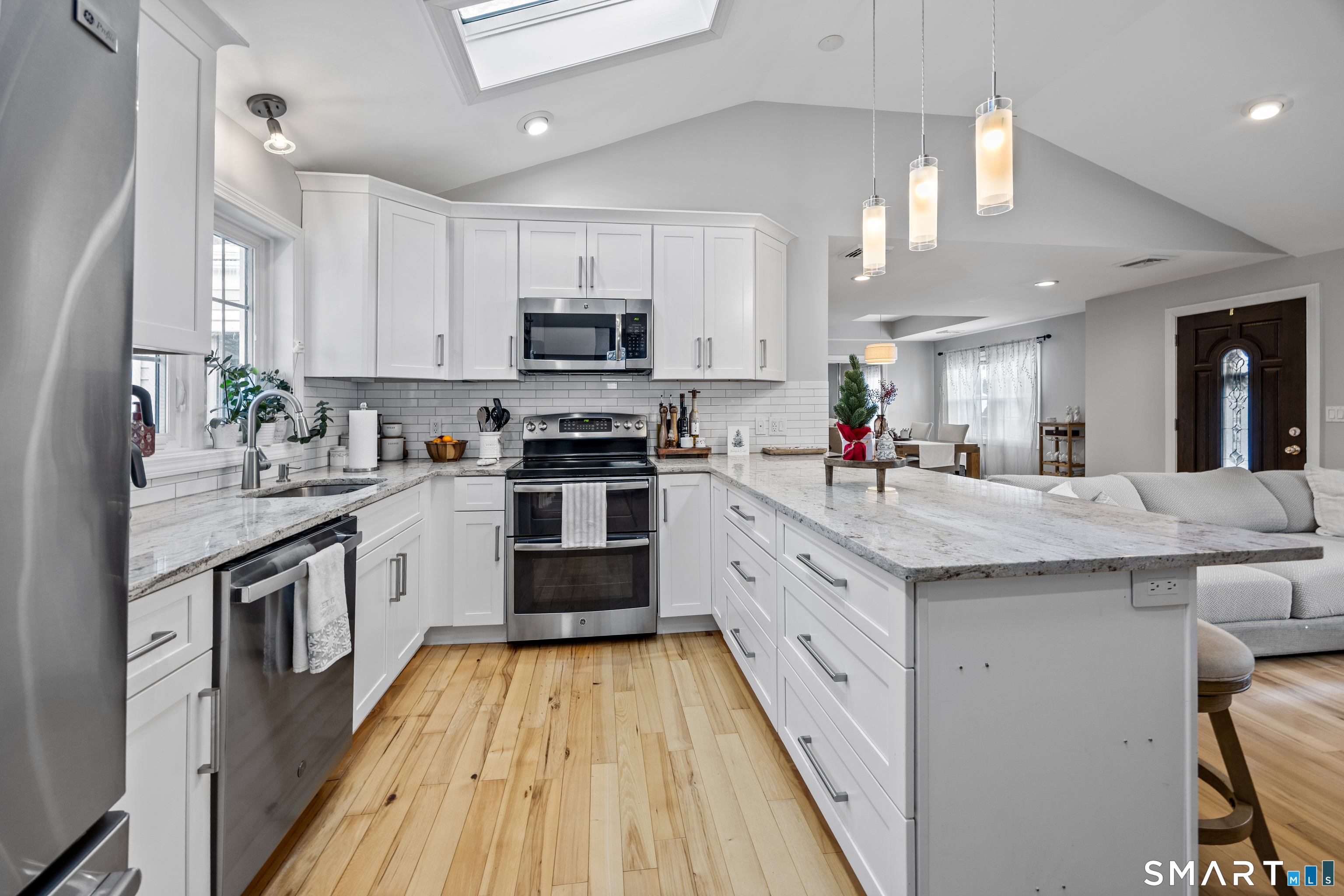29 Reliance Road Plainville, CT 06062 - Photo 2 of 25 a large kitchen with stainless steel appliances lots of counter space and wooden floor