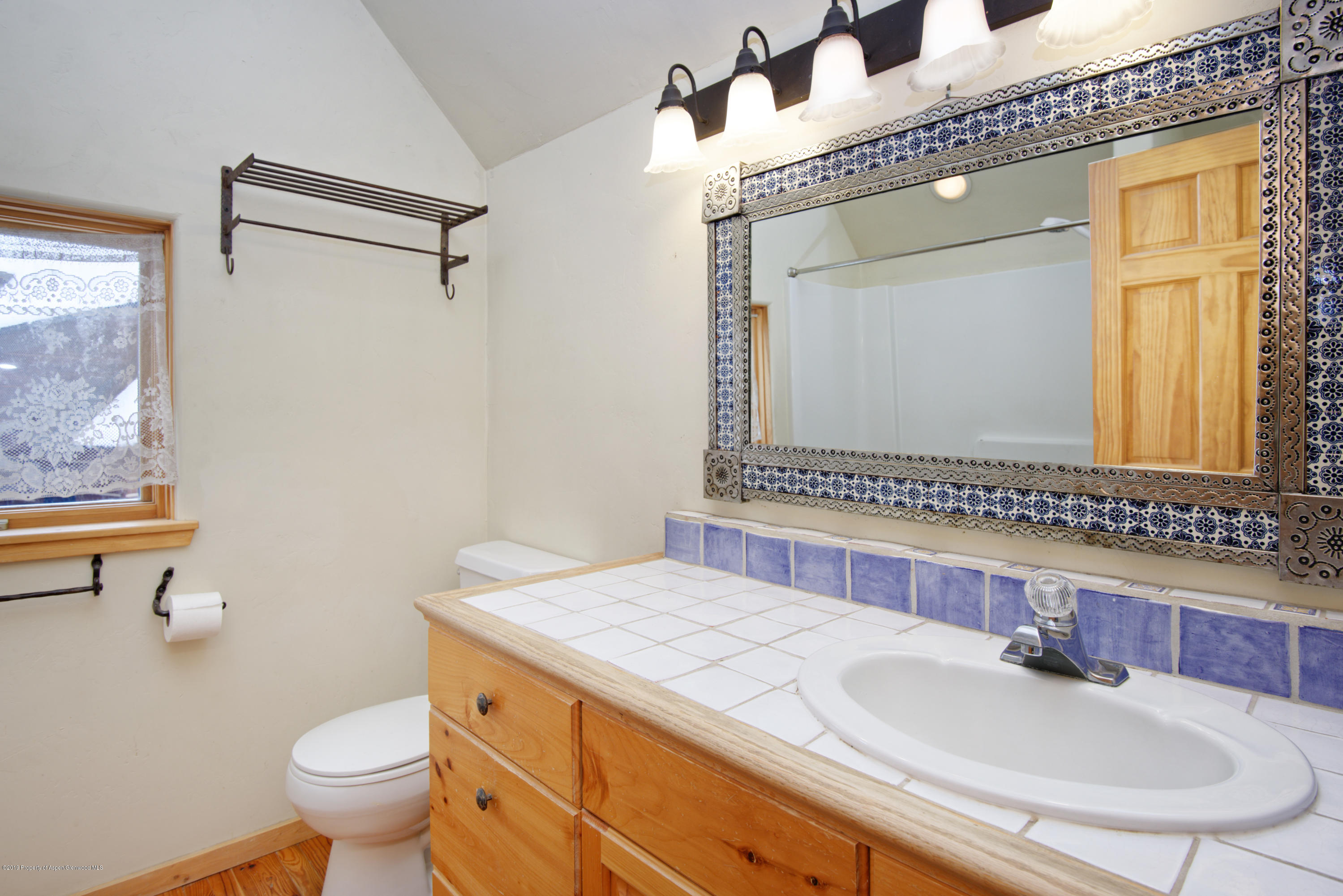 175 Village Court Basalt, CO 81621 - Photo 14 of 25 a bathroom with a granite countertop sink mirror vanity and toilet
