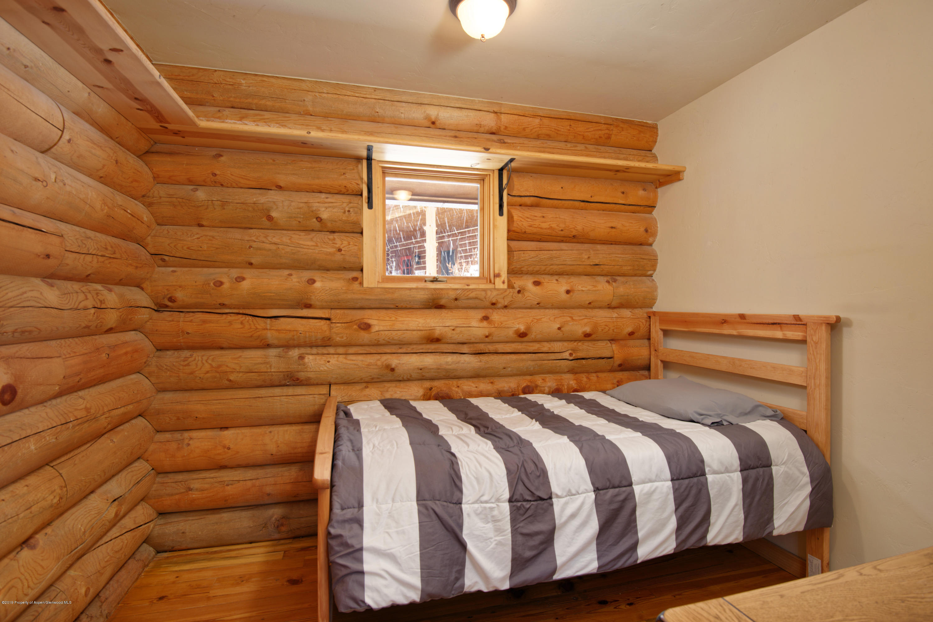 175 Village Court Basalt, CO 81621 - Photo 15 of 25 a bed sitting in a bedroom next to a window