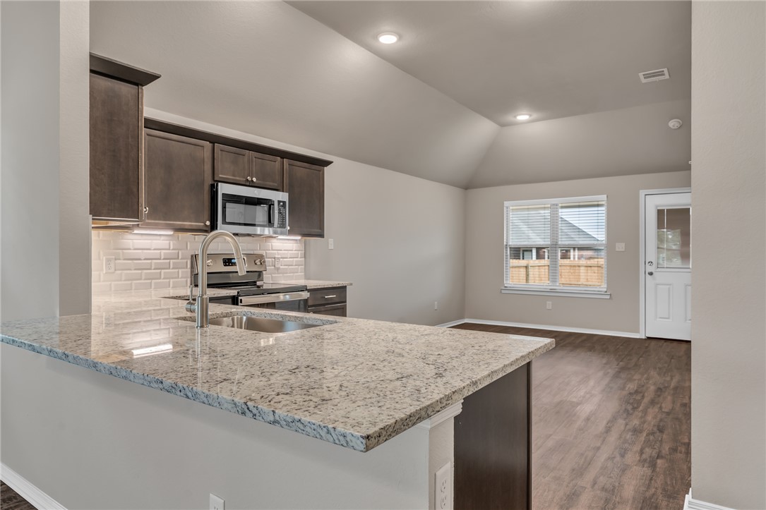 1236 High Street Navasota, TX 77868 - Photo 4 of 14 a kitchen with sink cabinets and microwave
