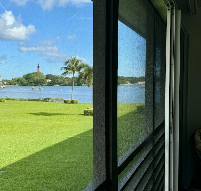 755 Saturn Street, Unit E201 Jupiter, FL 33477 - Photo 2 of 27 a view of lake from a window