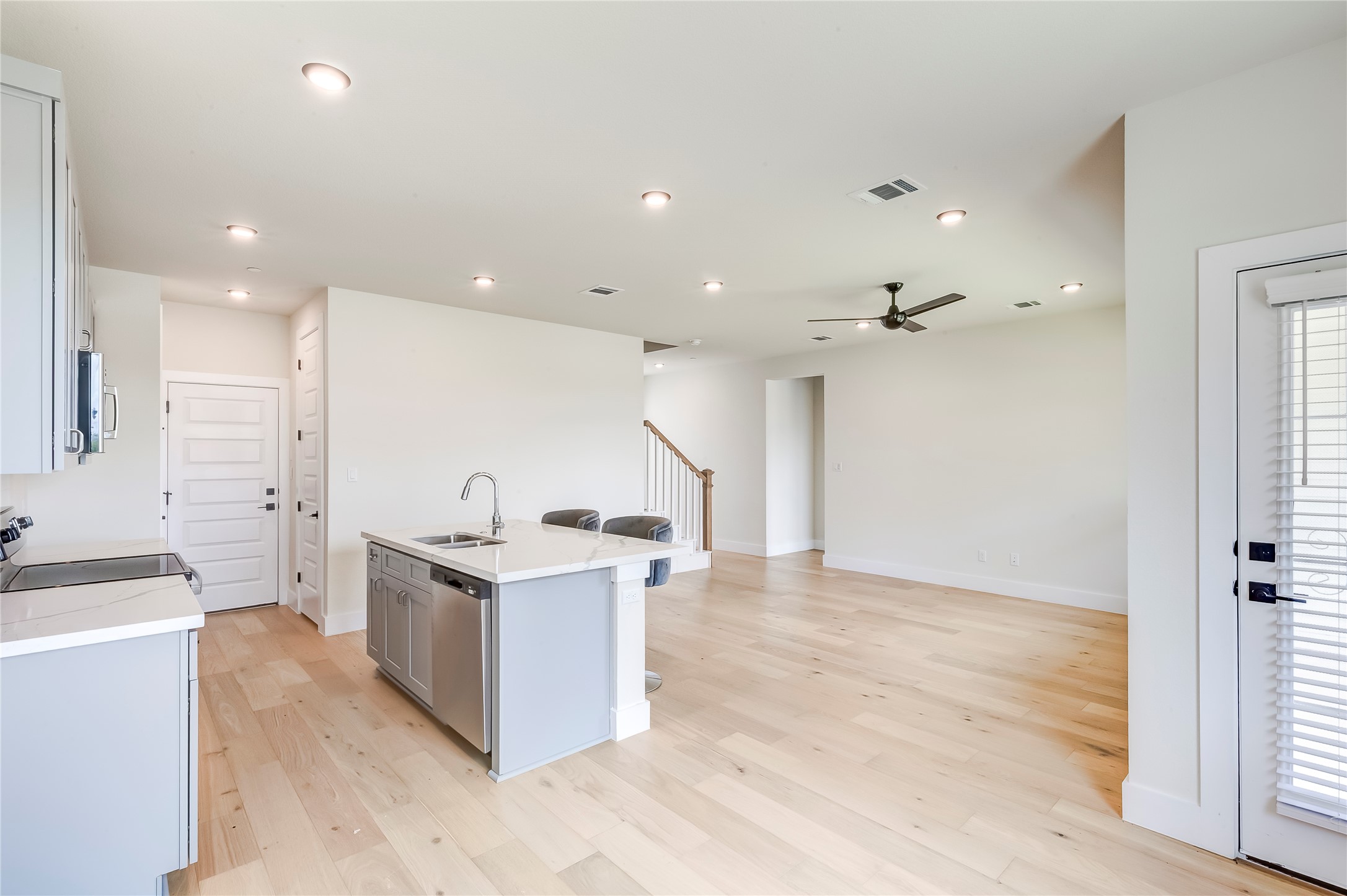 2600 Gattis School Road, Unit 401 Round Rock, TX 78664 - Photo 29 of 29 Kitchen with stainless steel appliances, a kitchen island with sink, ceiling fan, light wood-type flooring, and open floor plan