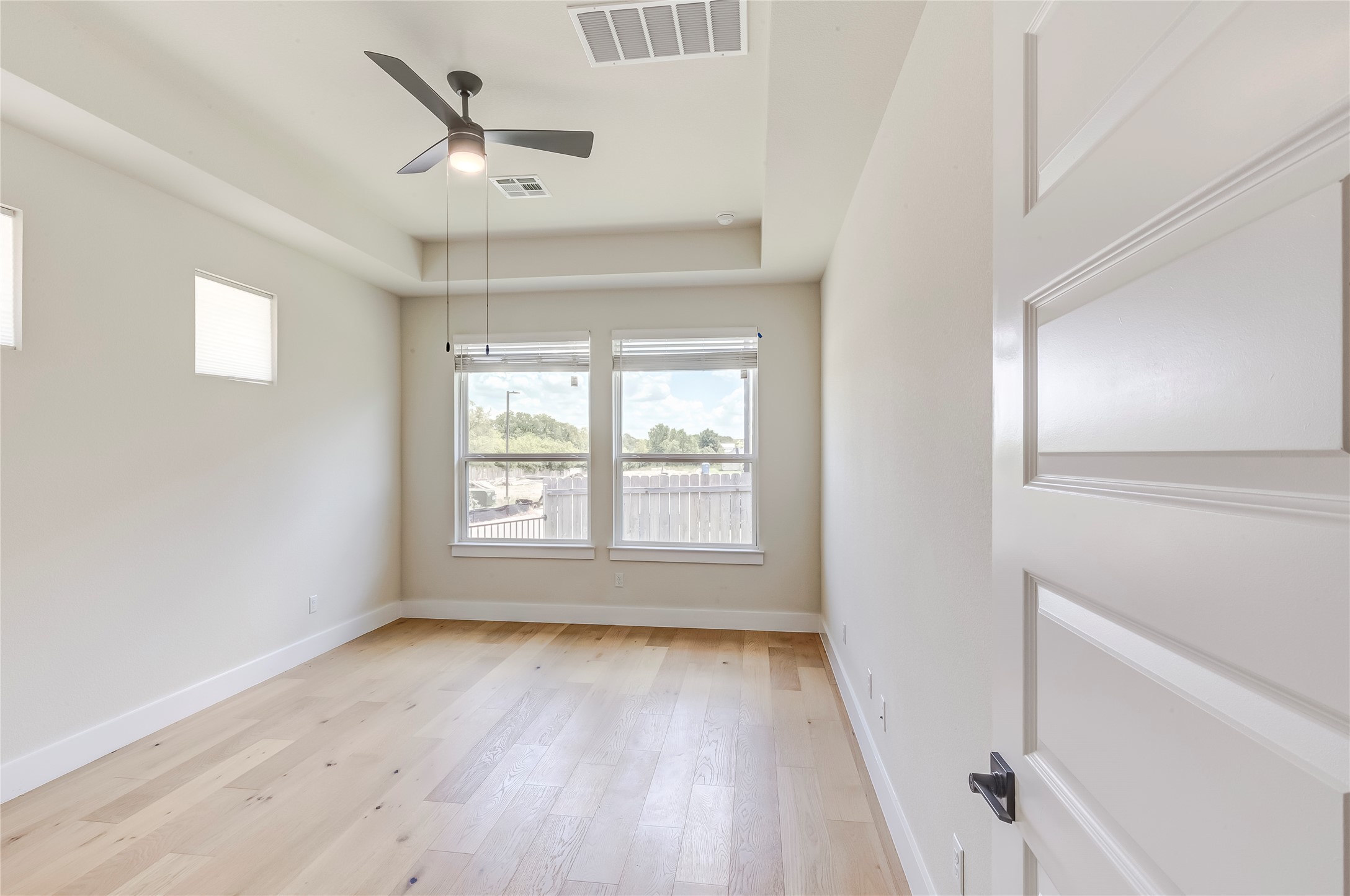 2600 Gattis School Road, Unit 401 Round Rock, TX 78664 - Photo 18 of 29 Spare room with a tray ceiling, light wood-type flooring, and ceiling fan