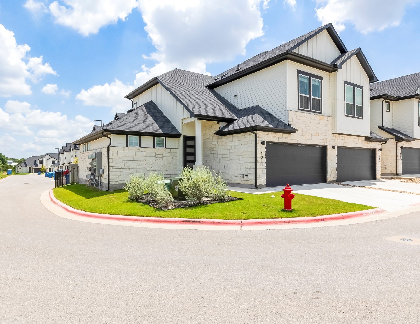 2600 Gattis School Road, Unit 401 Round Rock, TX 78664 - Photo 2 of 29 Modern inspired farmhouse with stone siding, board and batten siding, a garage, a shingled roof, and driveway
