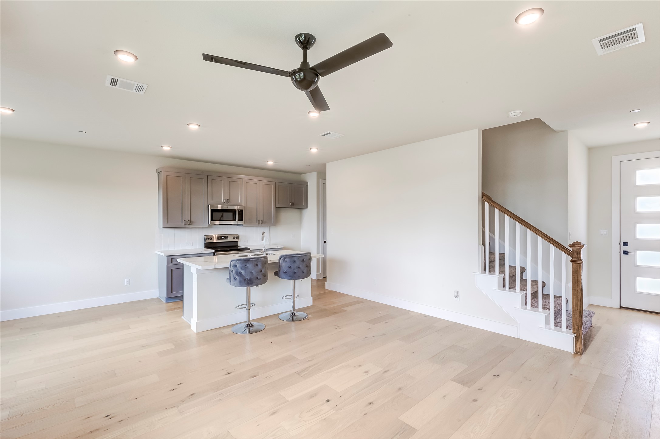 2600 Gattis School Road, Unit 401 Round Rock, TX 78664 - Photo 9 of 29 Kitchen with a breakfast bar, ceiling fan, an island with sink, light wood-style flooring, and stainless steel appliances