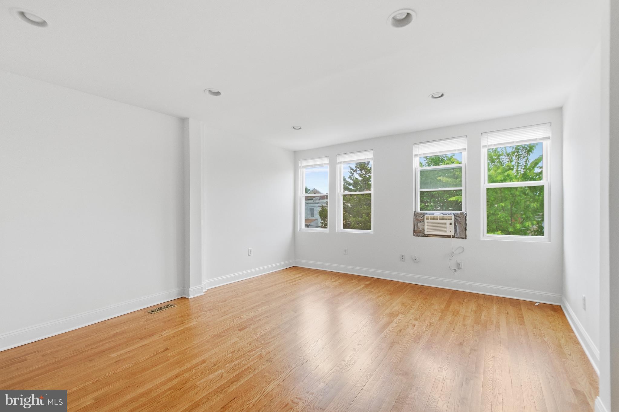 440 Delafield Place Northwest Washington, DC 20011 - Photo 18 of 33 an empty room with wooden floor and windows