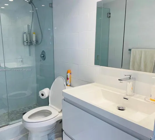 a bathroom with a toilet and a shower curtain