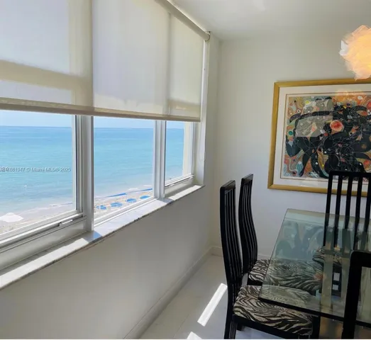 a view of a workspace room with wooden floor and windows