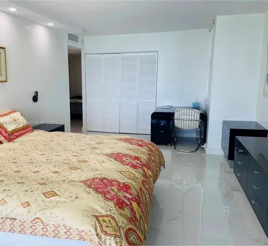 a bedroom with a large bed and a large window