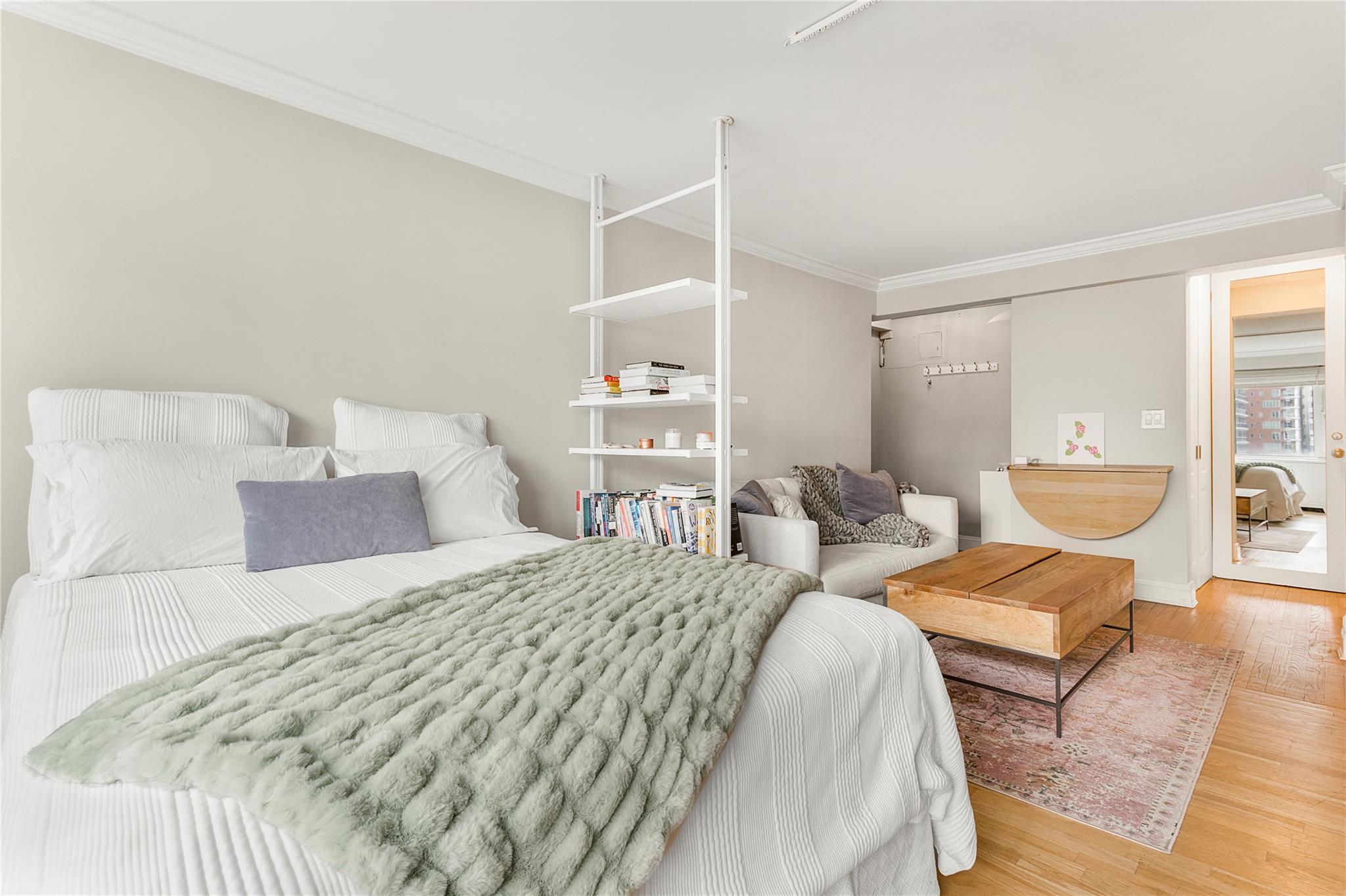 210 East 63rd Street, Unit 10E Manhattan, NY 10065 - Photo 2 of 15 Bedroom with crown molding, wood finished floors, and baseboards