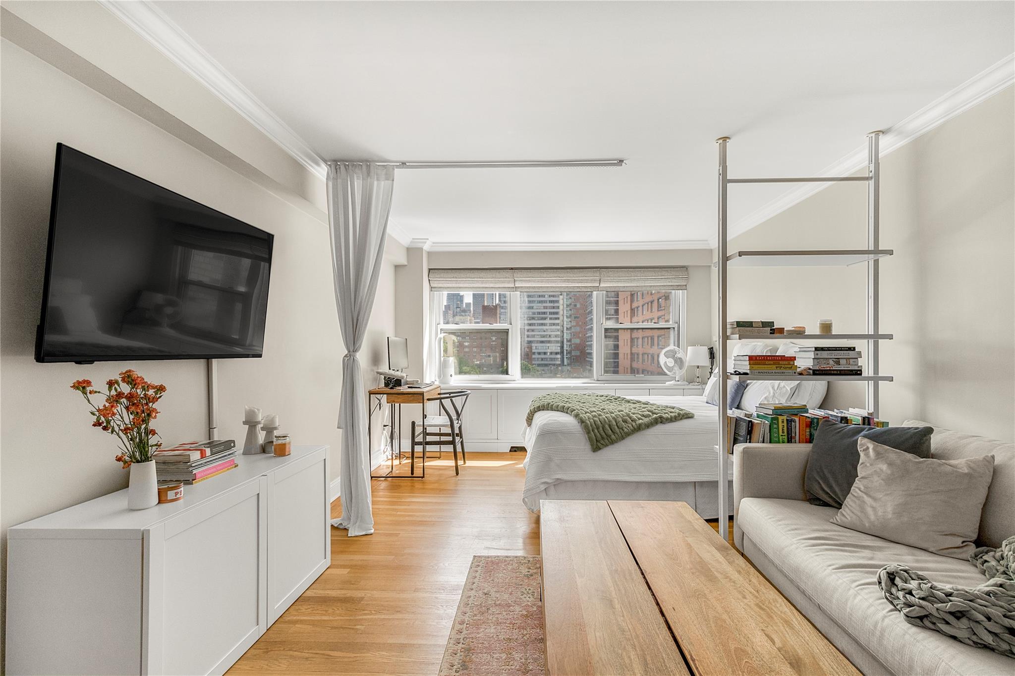 210 East 63rd Street, Unit 10E Manhattan, NY 10065 - Photo 8 of 15 Bedroom with ornamental molding and light wood-style flooring