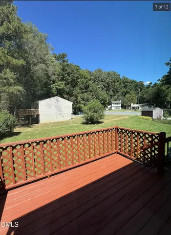 a view of a wooden deck with a yard