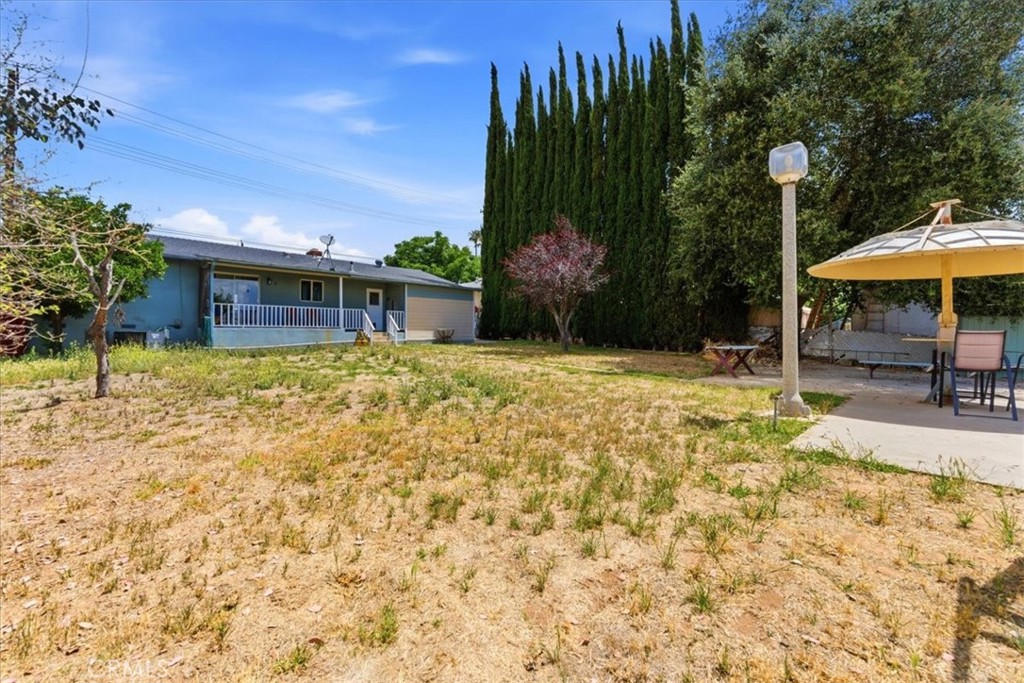 34863 Wildwood Canyon Road Yucaipa, CA 92399 - Photo 19 of 22 a swimming pool with outdoor seating and yard
