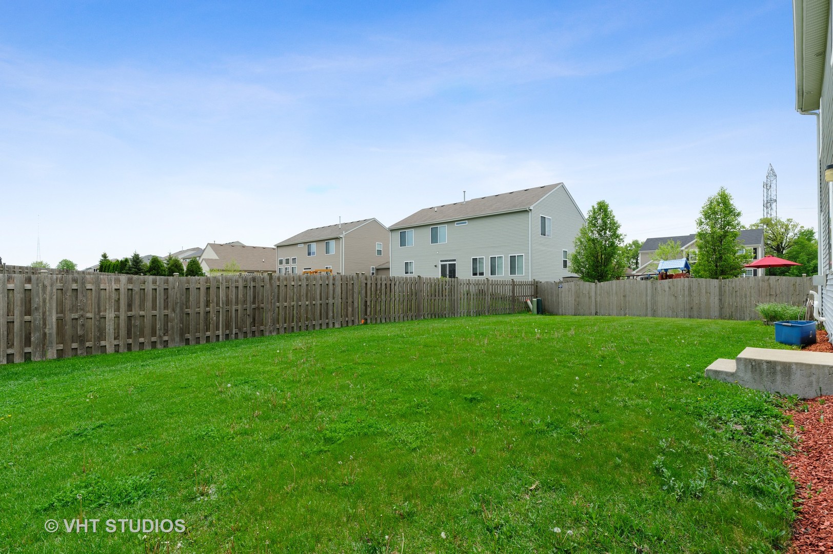 1439 Viola Lane Volo, IL 60073 - Photo 11 of 11 a view of a backyard with potted plants and wooden fence
