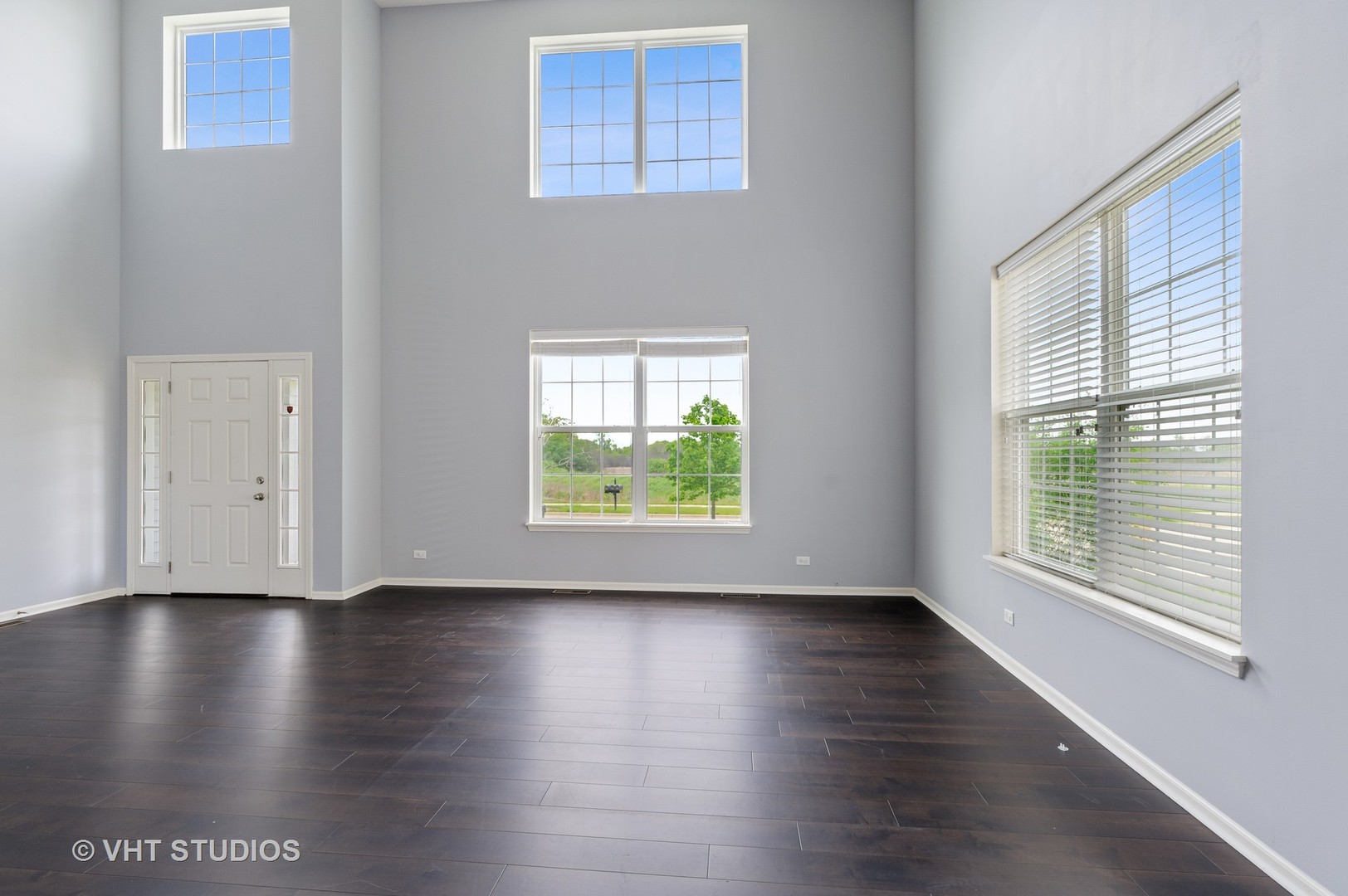 1439 Viola Lane Volo, IL 60073 - Photo 2 of 11 a view of an empty room with wooden floor and a window
