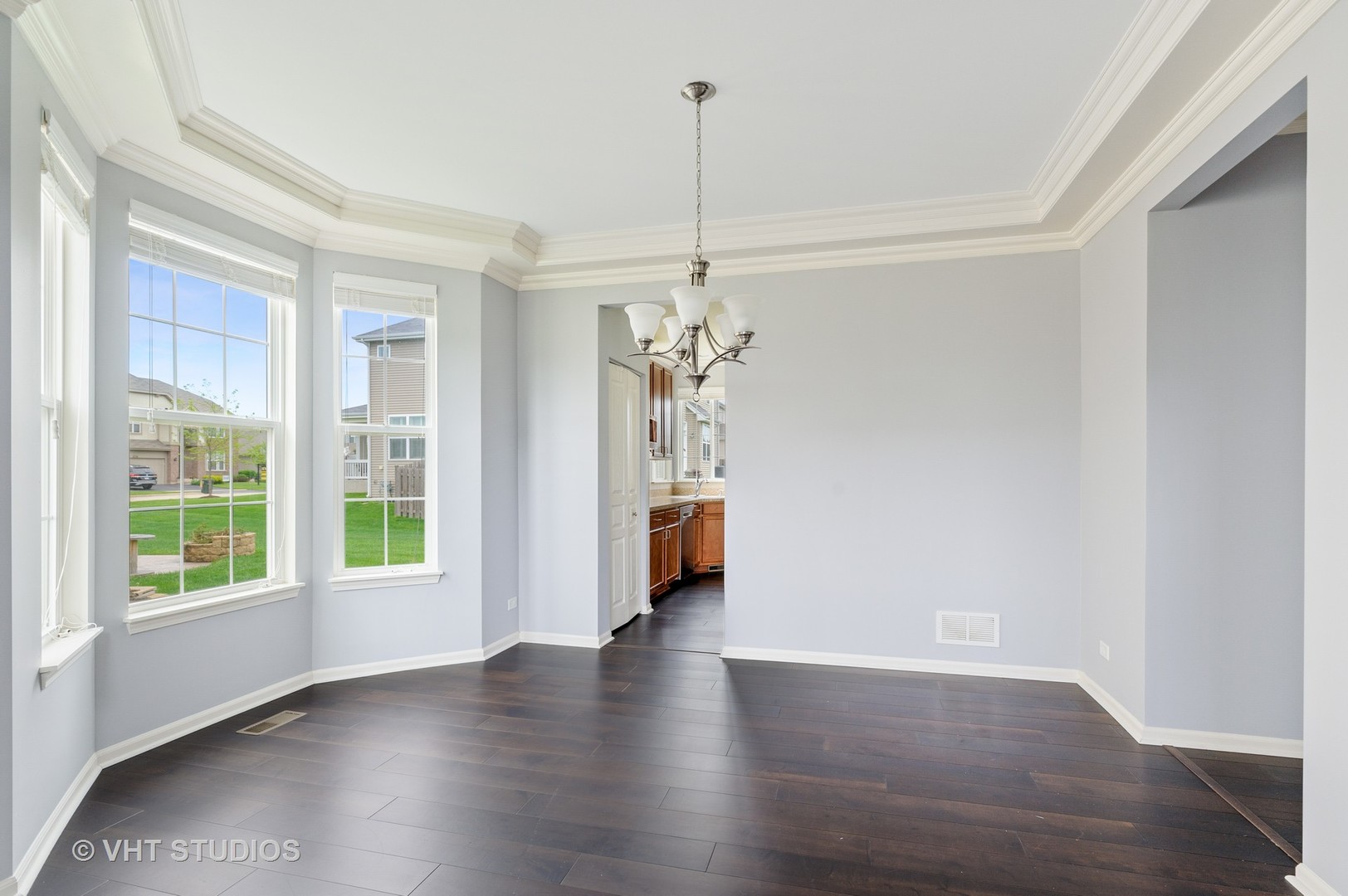 1439 Viola Lane Volo, IL 60073 - Photo 4 of 11 a view of a room with wooden floor chandelier and windows