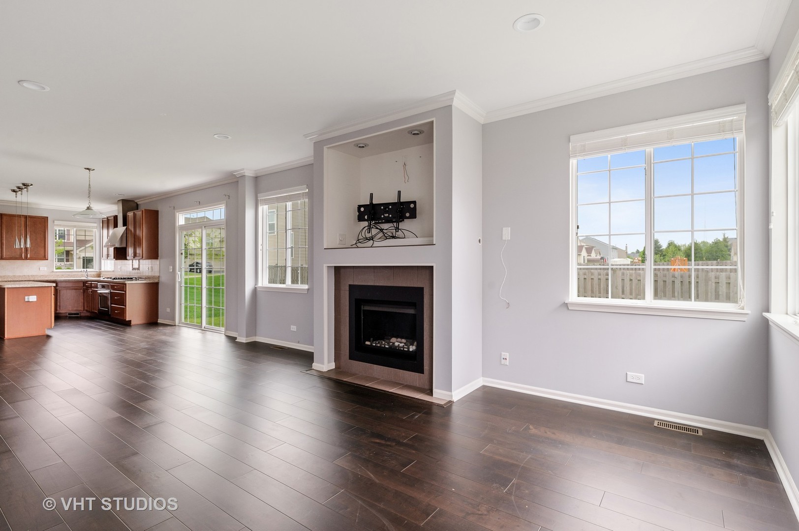 1439 Viola Lane Volo, IL 60073 - Photo 6 of 11 a view of a big room with wooden floor a fireplace and windows
