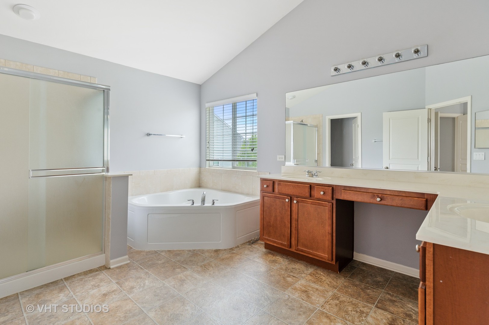1439 Viola Lane Volo, IL 60073 - Photo 9 of 11 a spacious bathroom with a tub sink and mirror