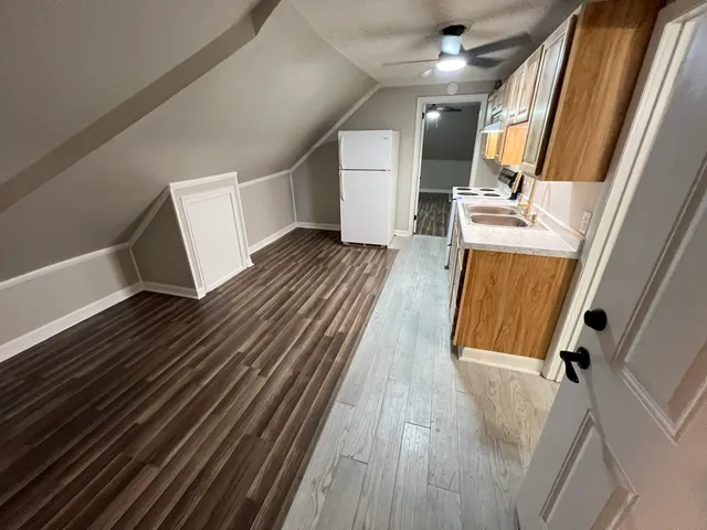 a view of a room with wooden floor and staircase
