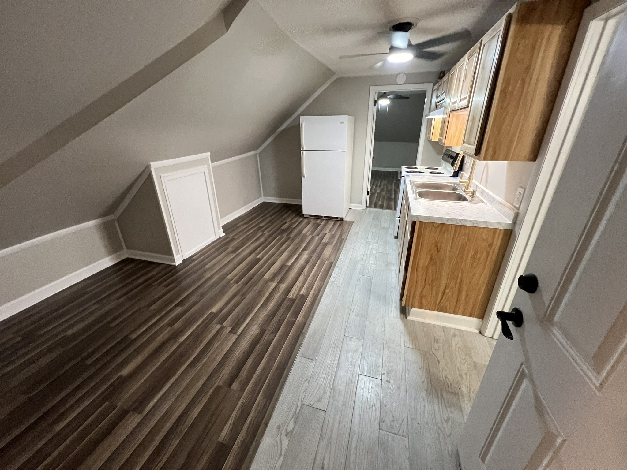 a view of a room with wooden floor and staircase