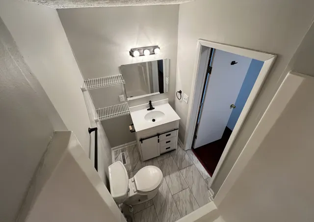 a living room with furniture and a mirror