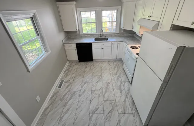 a kitchen with a refrigerator and window