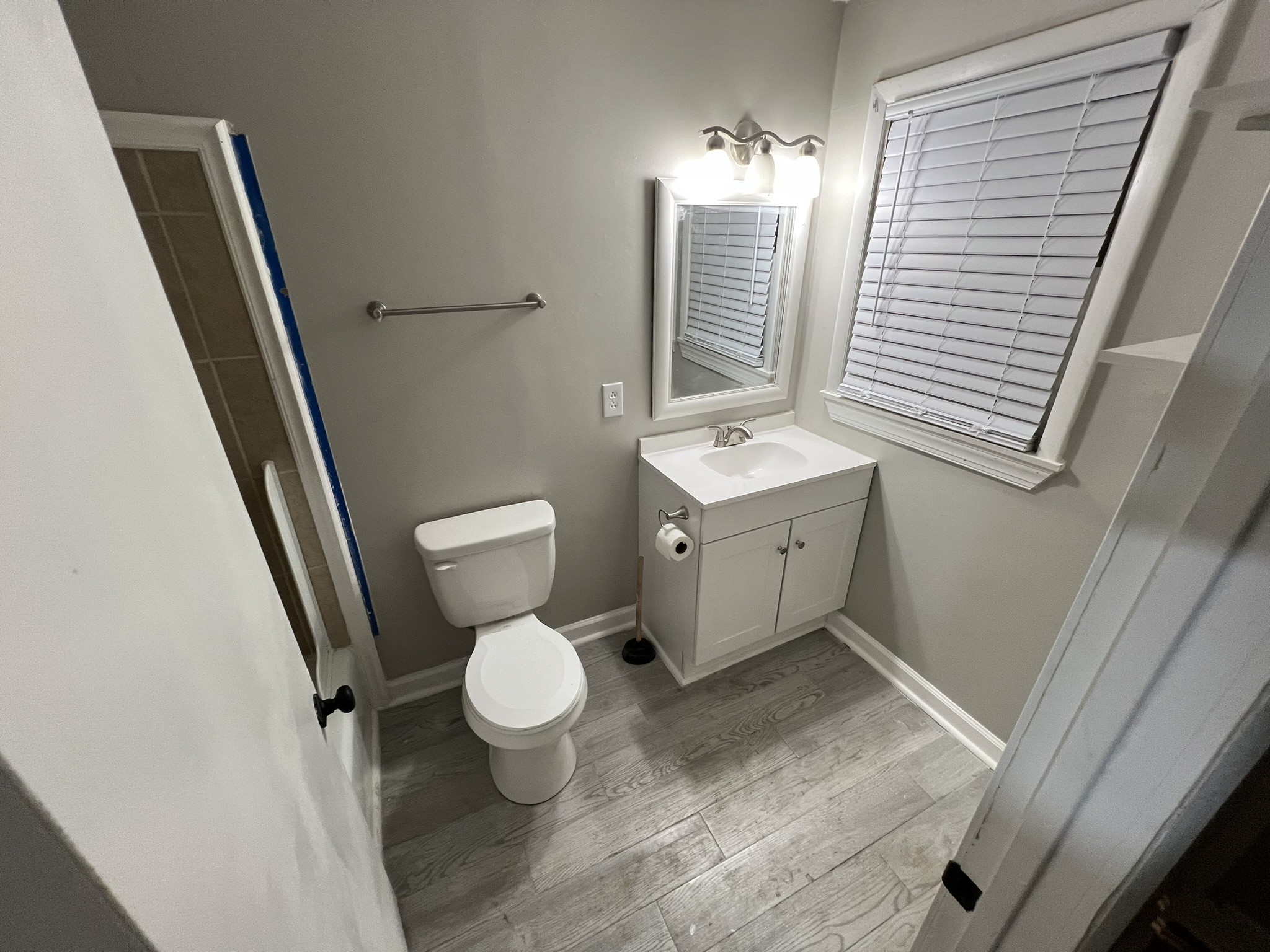 721 North Maple Street, Unit C Murfreesboro, TN 37130 - Photo 6 of 8 a bathroom with a toilet sink and mirror