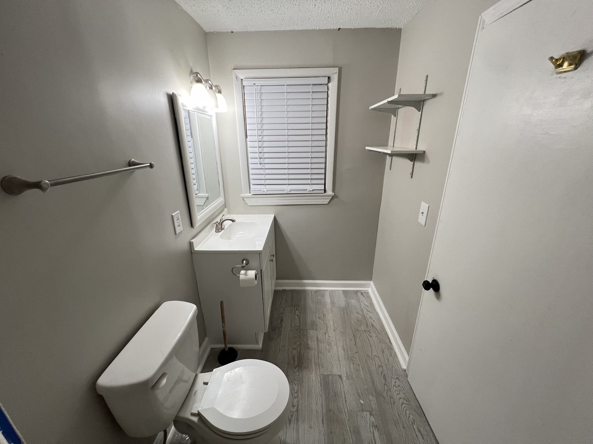 721 North Maple Street, Unit C Murfreesboro, TN 37130 - Photo 7 of 8 a white toilet sitting next to a bathroom sink
