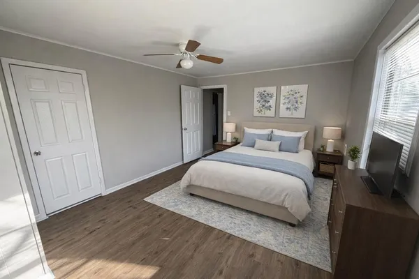 a bedroom with a large bed and a window