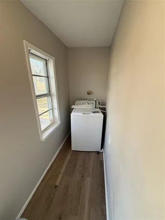 a room with a window and wooden floor